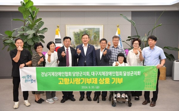 ▲담양군과 대구 달성군 한국지체장애인협회가 고향사랑기부금을 각 지자체에 상호 기탁하며 고향사랑의 마음을 전달했다.(사진제공=담양군)