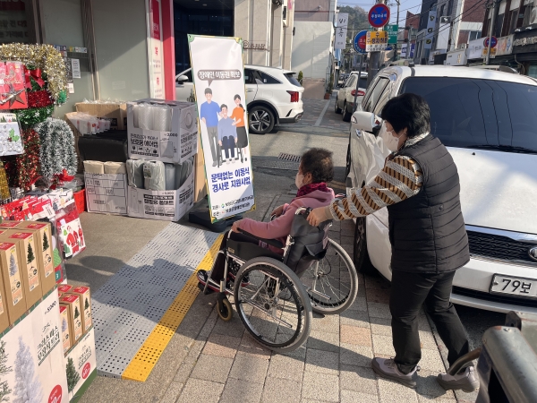 ▲주민들이 이동식 경사로를 이용하여 상가로 들어가고 있다.(사진제공=보성군)