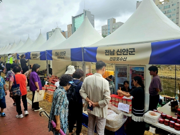 ▲신안군 자매결연지 은평구에서 열린 추석맞이 직거래장터에서 시민들이 신안군 특산물 판매 부스를 둘러보고 있다.(사진제공=신안군)